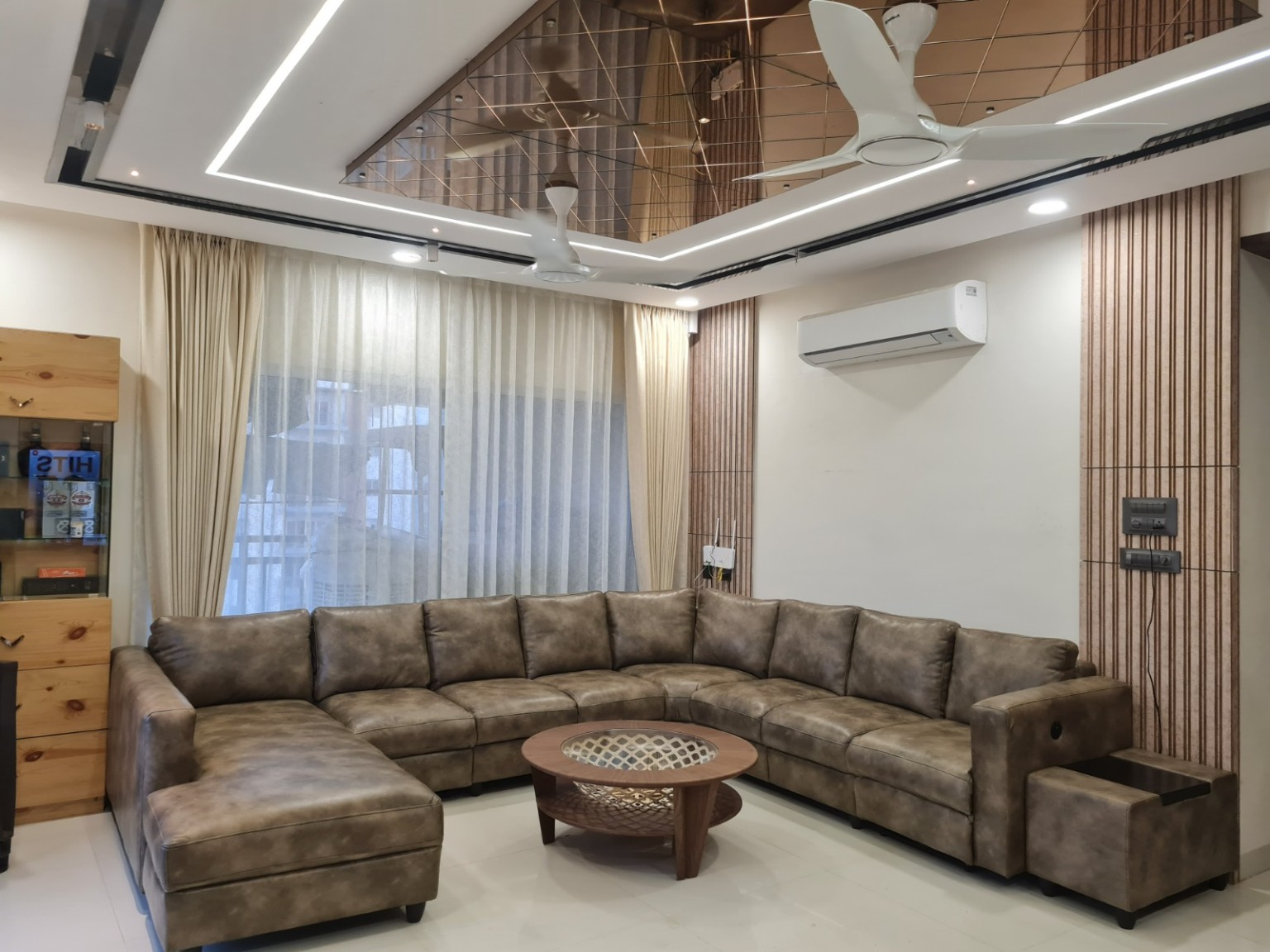 Completed living room with sectional sofa and decorative ceiling