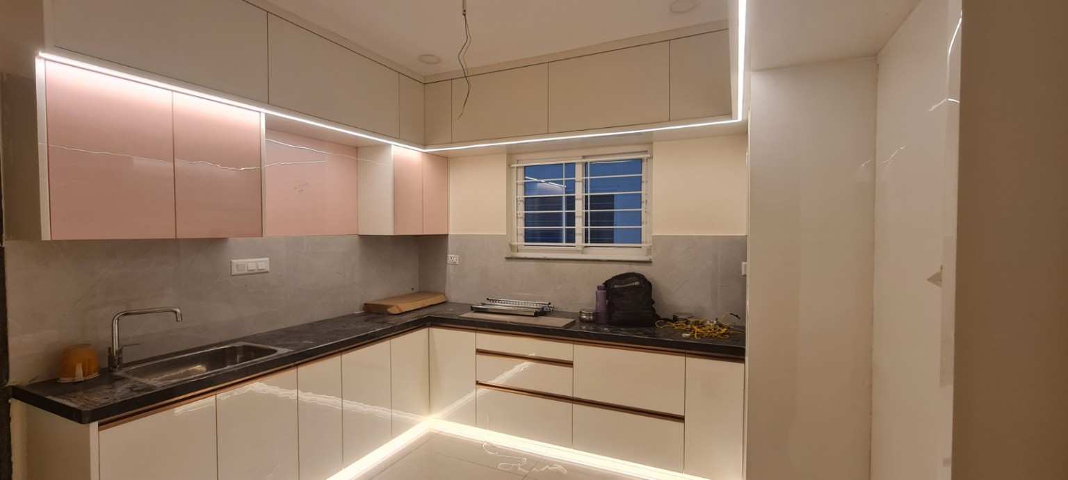 Completed ivory modular kitchen with illuminated upper cabinets