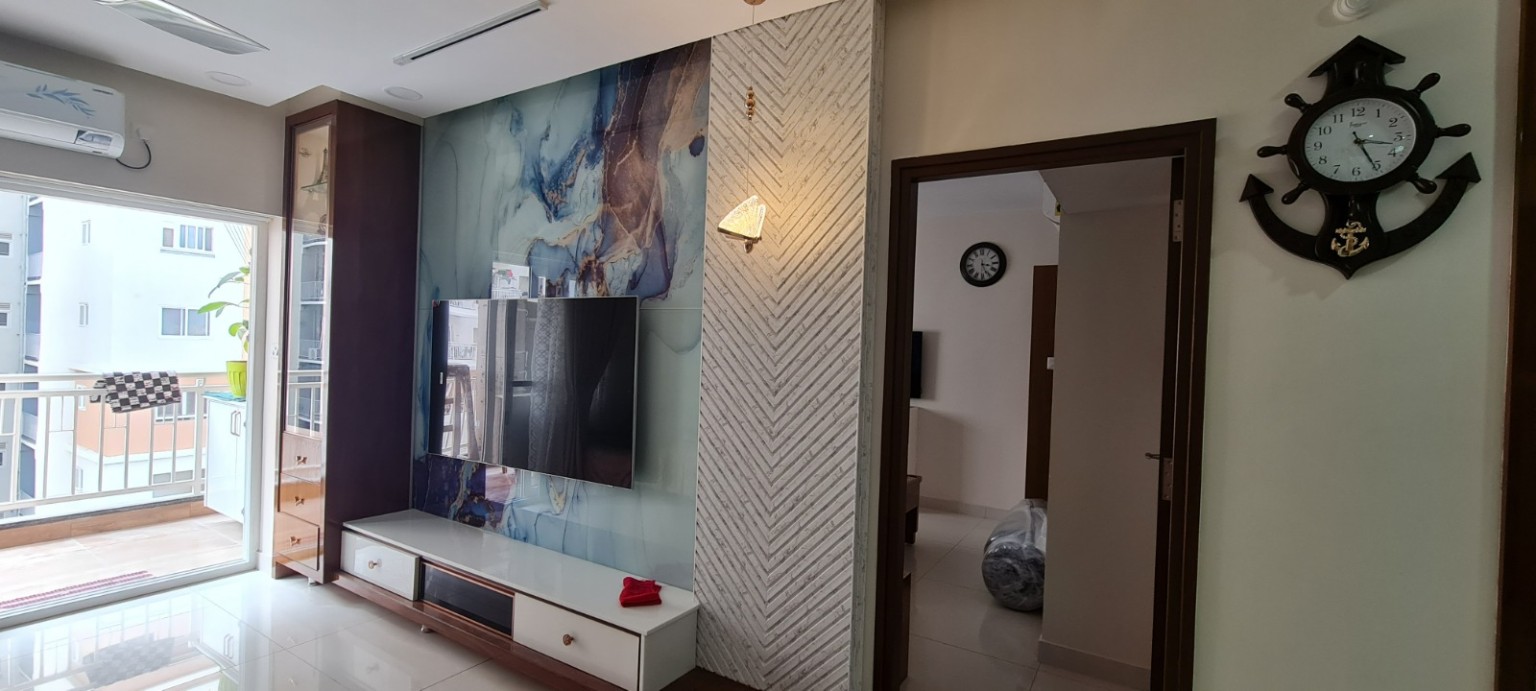 Completed living room TV wall with decorative panels and storage